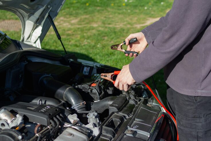 Man charging his electric car with a charging cable