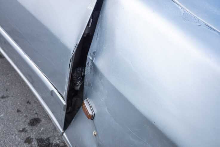 Detail of a car door deformed by impact