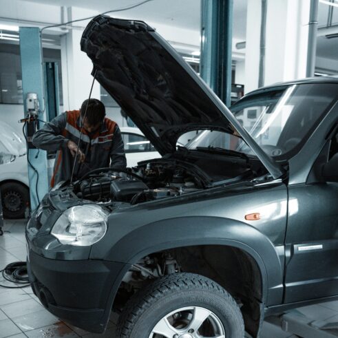 Mechanic performing maintenance near the engine