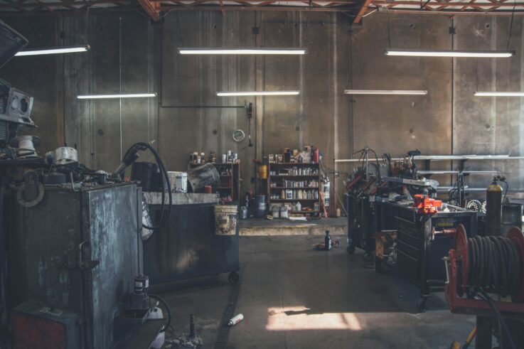 Collision repair garage interior with vehicles and tools