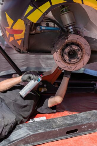 Mechanic applying spray to wheel rail